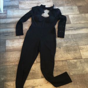 Black jumpsuit with lace sleeves and collar.